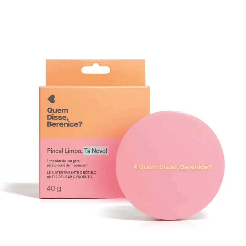 Umagem de um pote com tampa rosa em formato circular de limpador de pincéis da marca Quem Disse, Berenice?, com texto "Pincel Limpo, Tá Novo!" e informações sobre o produto. Ao lado está sua caixa na cor rosa e laranja com letras pretas.