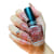 Modelo com as unhas pintadas segurando o frasco do Esmalte Glitter Cuccio Brasil Colour Love Potion Nº9 1107 13ml