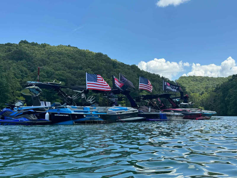 Customer photo: flags flying on boats on a lake