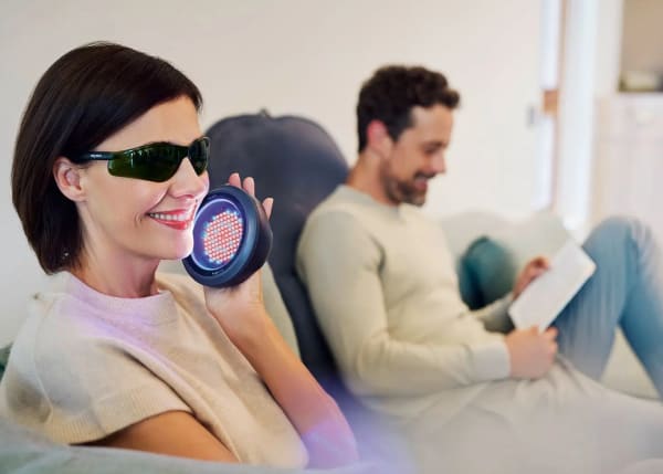 Puts your skin in the best light – couple in living room using the B.Spot and B.Body