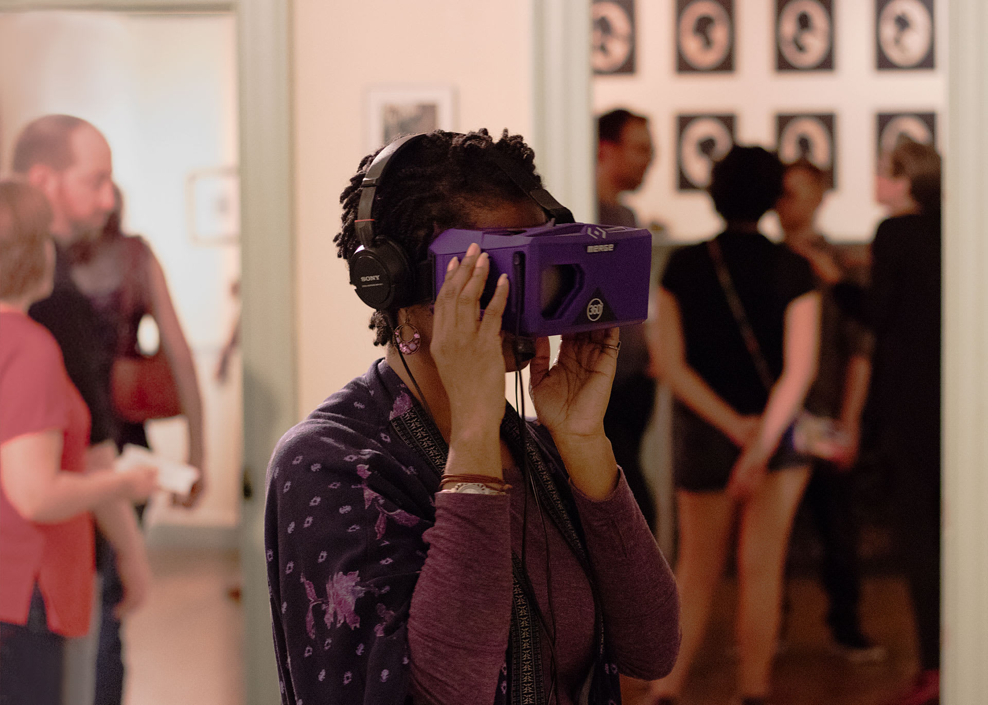 A woman wearing a purple VR headset