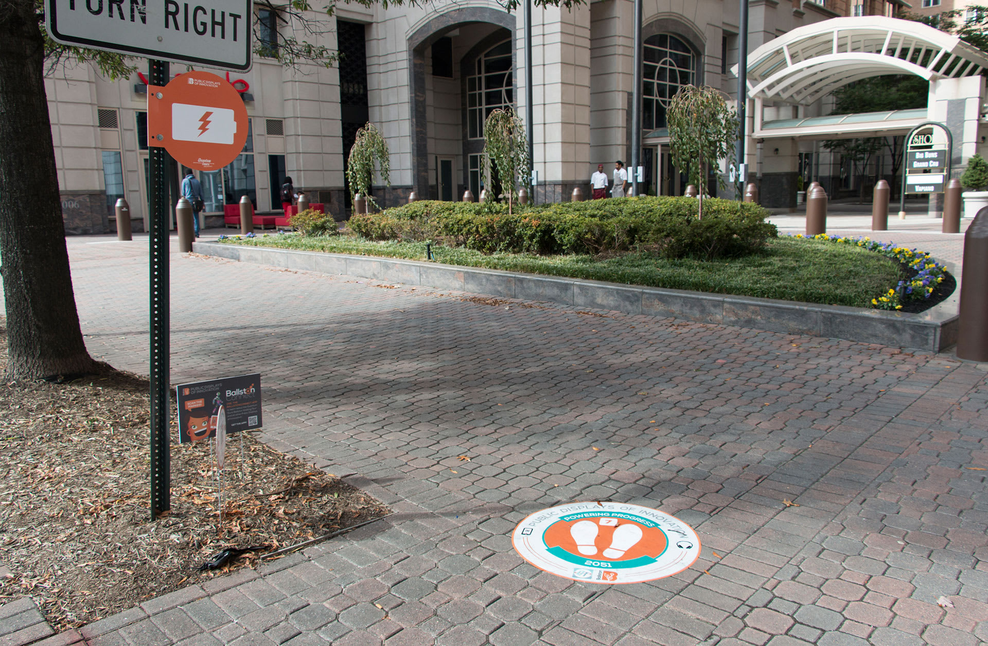 Sidewalk decal and streetpost sign in a city street