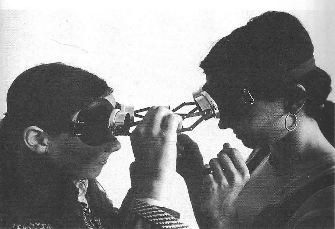 Two people wearing connected goggles by Lygia Clark