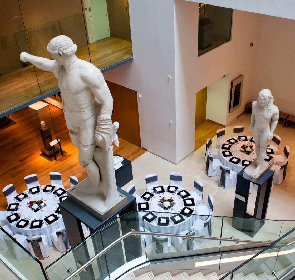 A high angle photo looking down on the tables that have been laid for an event