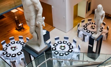 A high angle photo looking down on the tables that have been laid for an event