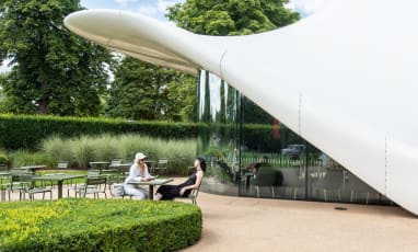 An external shot of The Magazine with 2 people sat at a table