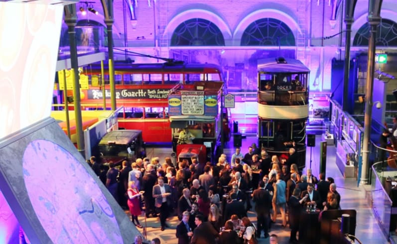 A high angle photo of people standing in a large event space