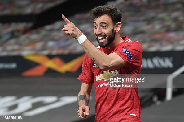 MANCHESTER, ENGLAND - APRIL 29: Bruno Fernandes of Manchester United celebrates after scoring their team's first goal during the UEFA Europa League Semi-final First Leg match between Manchester United and AS Roma at Old Trafford on April 29, 2021 in Manchester, England. Sporting stadiums around Europe remain under strict restrictions due to the Coronavirus Pandemic as Government social distancing laws prohibit fans inside venues resulting in games being played behind closed doors. (Photo by Michael Regan/Getty Images)