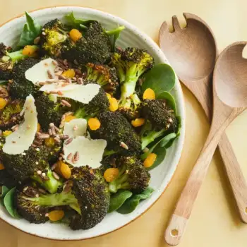 Charred Broccoli Salad with Nutritional Yeast, Parmesan Cheese, Sunflower Seeds and Golden Raisins
