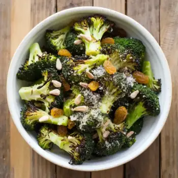 Charred Broccoli Salad with Nutritional Yeast, Parmesan Cheese, Sunflower Seeds and Golden Raisins