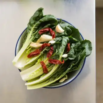 Sauteed Escarole with Garlic, Sun-dried Tomatoes, and Artichoke Hearts