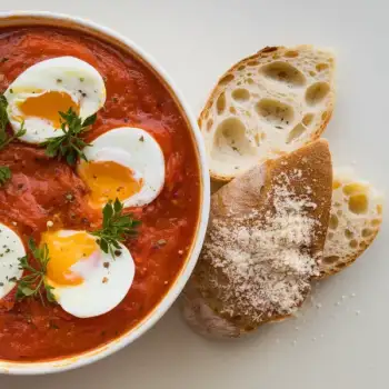Spicy Tomato Poached Eggs with Garlic Pecorino Toasts