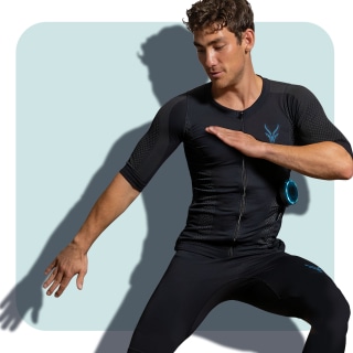 A well-trained young man in a dynamic pose wears the Antelope EMS suit with leggings A well-trained young man in a dynamic pose wears the Antelope EMS suit with leggings