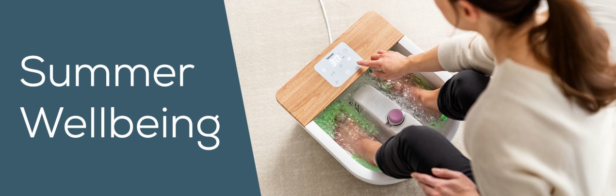 Beurer "Summer Wellbeing" campaign Banner showing a woman using the Beurer Foothbath FB 65