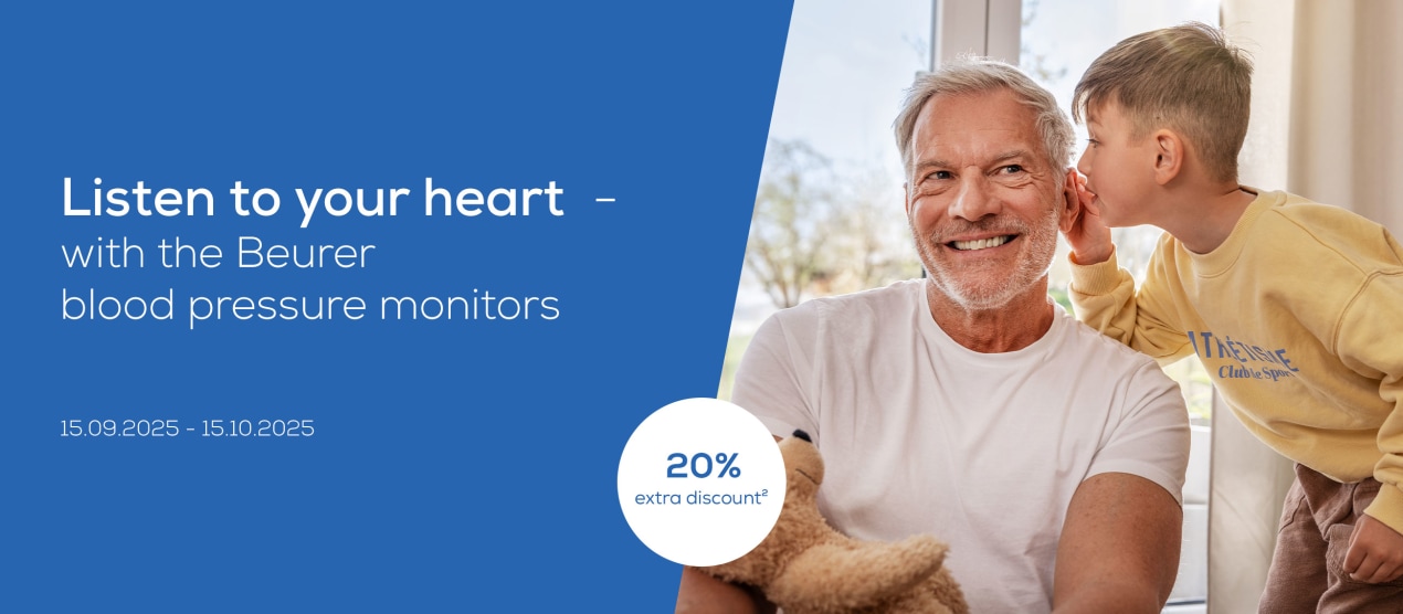 "A good feeling - with every measurement. For your heart health". Child on the right hugs older man, laughing, covers his eyes.
