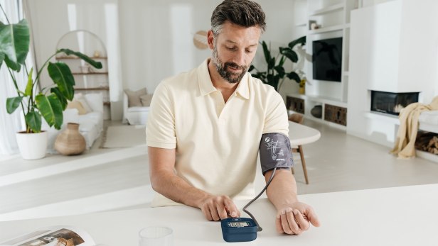 Un homme mesure sa tension artérielle avec le tensiomètre Beurer BM 25