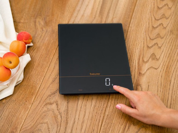 Küchenwaage KS 34 Anwendwungsbild Eine Hand bedient die Küchenwaage KS 34 von Beurer