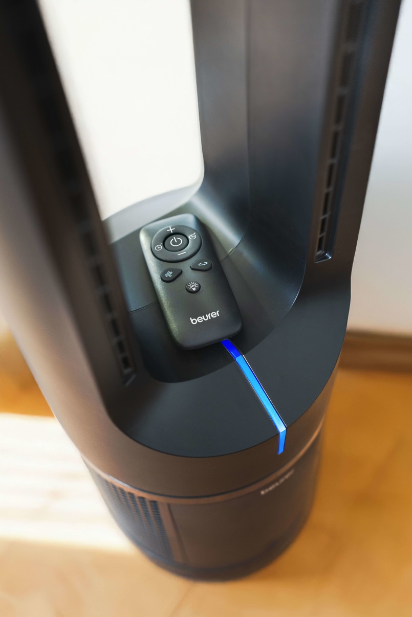 Nahaufnahme der Mitte des Beurer LV 500; im Detail wird der farbige Luftqualitätsindikator und die magnetische Fernbedienung gezeigt