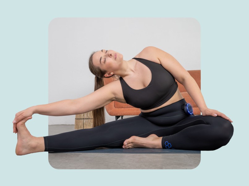 Frau führt auf einer Yoga Matte eine Übung aus mit einem Bein in der Luft