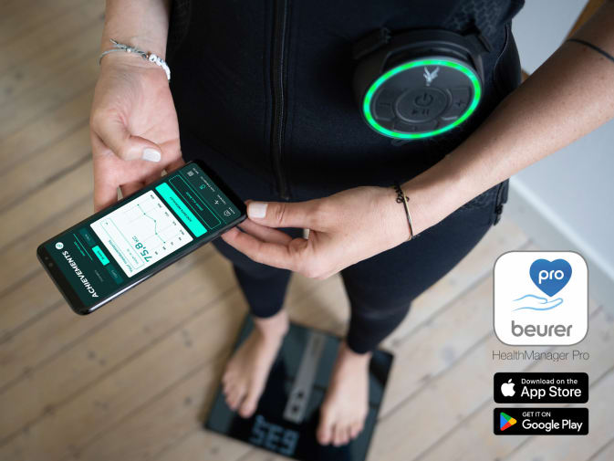 A woman stands on a Beurer smart scale and tracks her weight loss in the Antelope Go app.