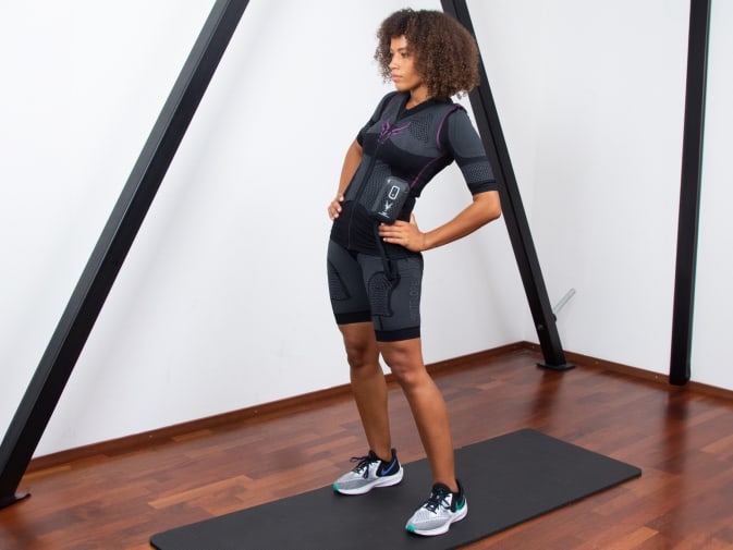 A woman performs a cool down after EMS training with Antelope in her home.