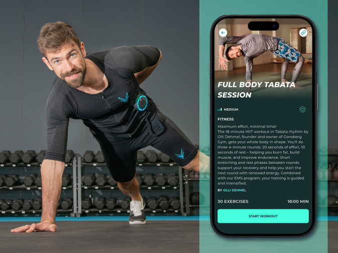 Olli does a push-up with one arm. He is wearing the EMS suit from Antelope. His training is shown on an app screen next to him.