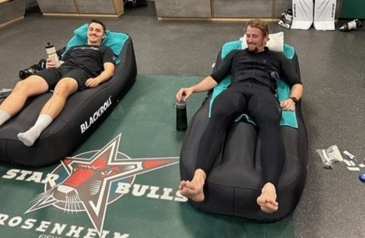 Two young men resting after EMS training.