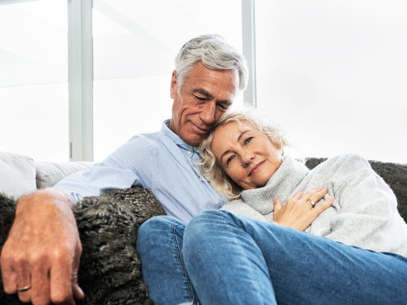 Couple lying healthy and content on the sofa