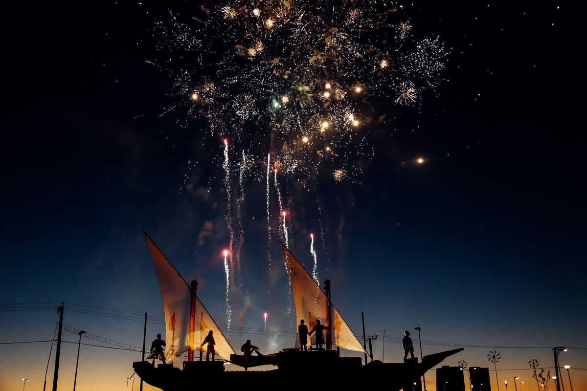 friends scattering ashes firework on a boat