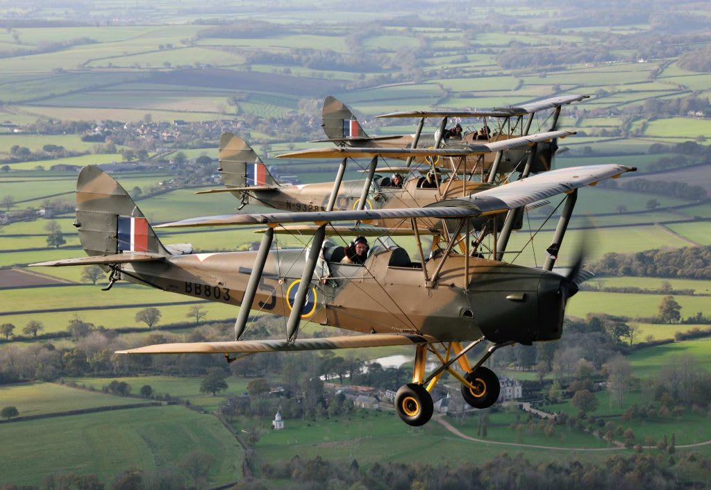 Ashes being scattered from a vintage wartime Tiger Moth Ashes being scattered from a vintage wartime Tiger Moth