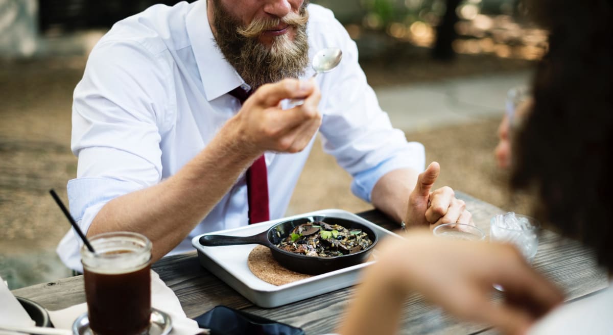 Man eating dinner and explaining why his moustache was worth being disinherited