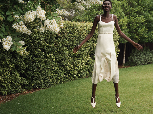 Model wears Gabriela Hearst - Godard Pleated Midi Dress with Crochet Inserts