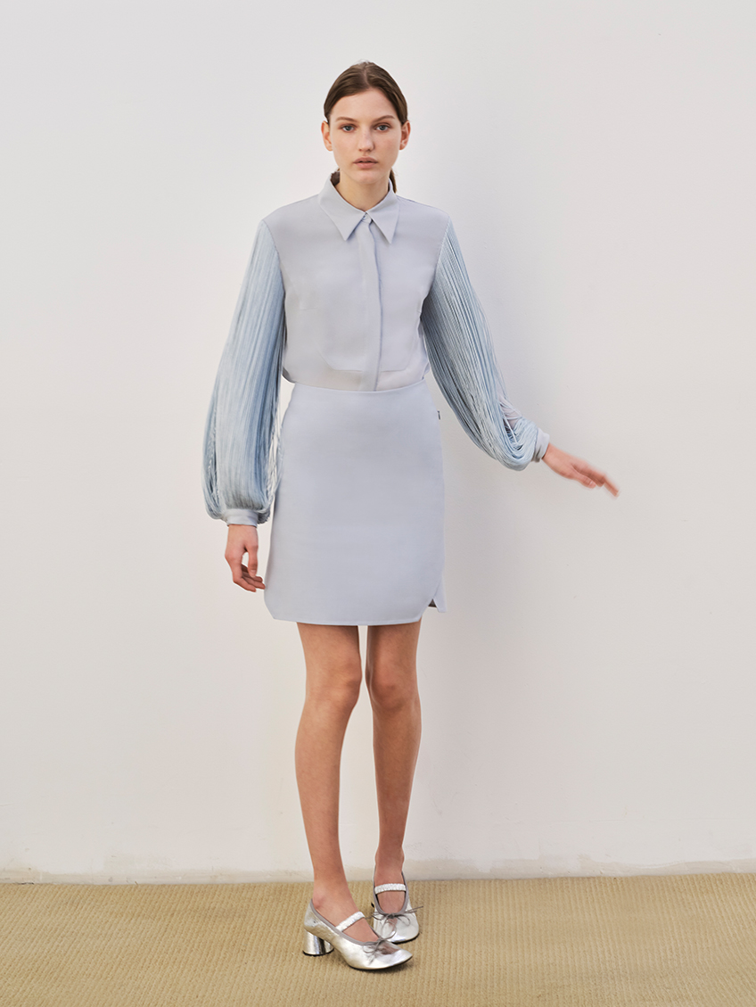 Model Wears Akris - blouse, silk crepe body and Cotton Short Skirt with Trapezoid Slit Detail