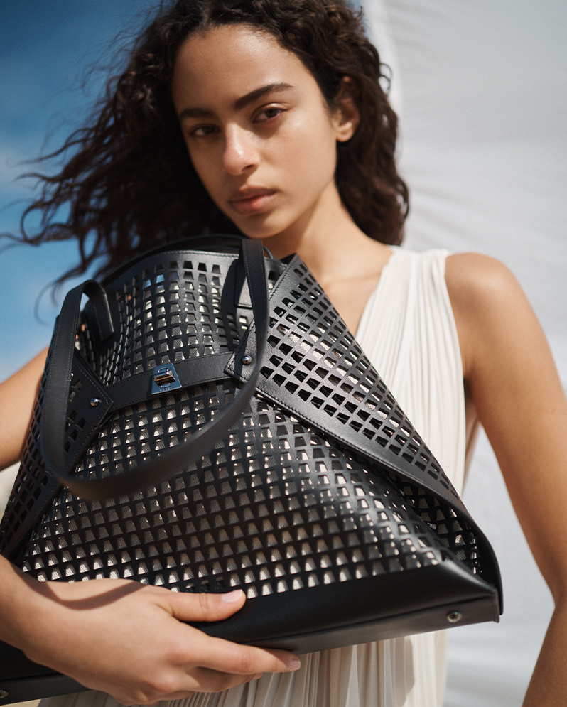 Model Wears Akris- Ai Medium Laser Cut Shoulder Bag