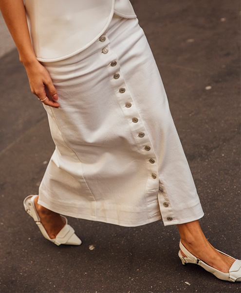 Model wears Courrges - Denim Buttoned Midi Skirt