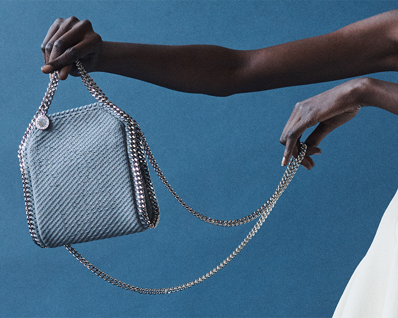 Model holds Stella MCcartney - Falabella Mini Tiny Mesh Vegan Leather Tote Bag