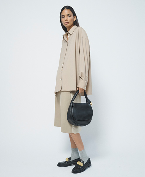 Model wears Armarium - Leo Wool Button-Front Shirt and Jil Sander - Relaxed Wool Trouser Shorts