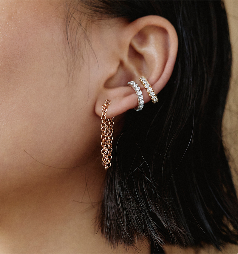 Model wears Spinelli Kilcollin - 18K Yellow Gold Eclipse Pave Diamond Ear Cuff and Anaka XL Chain Dangle Earrings