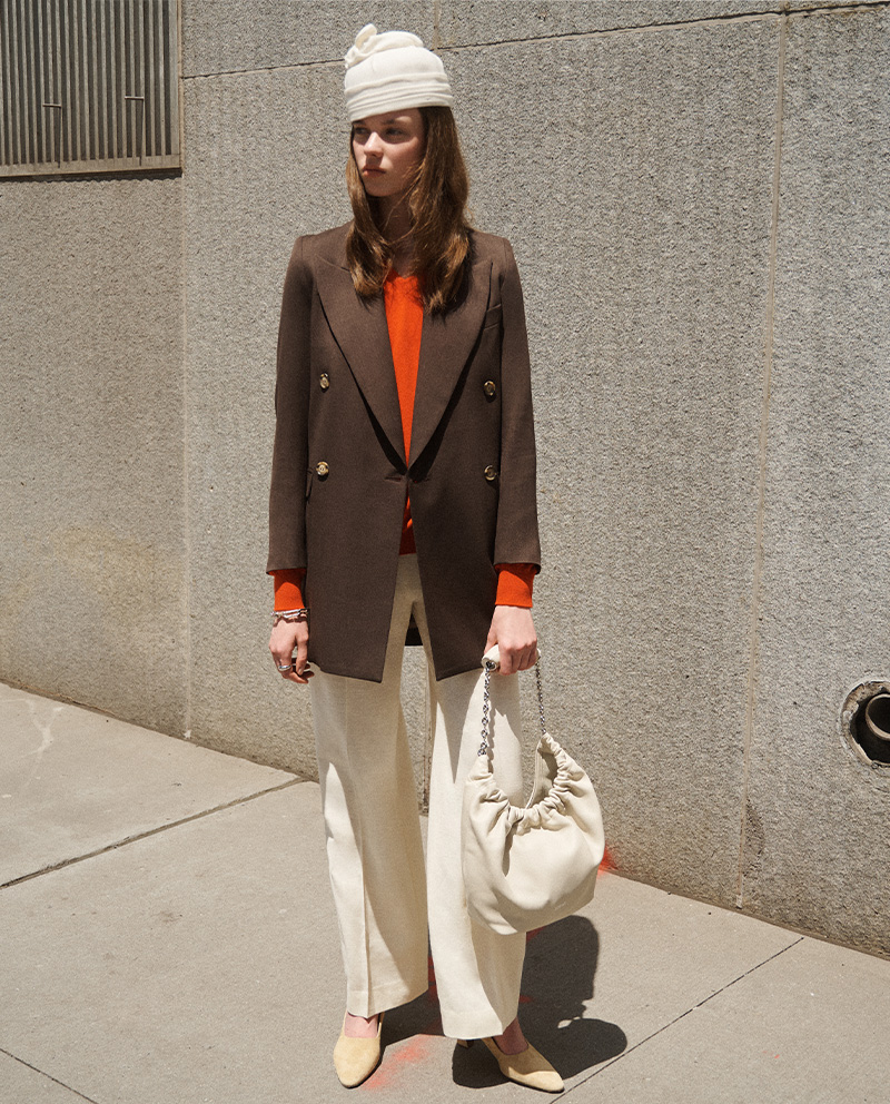 Model Wears The Row - Gracy V-Neck Cashmere Sweater and Antone Pintuck Wide-Leg Wool Pants, White