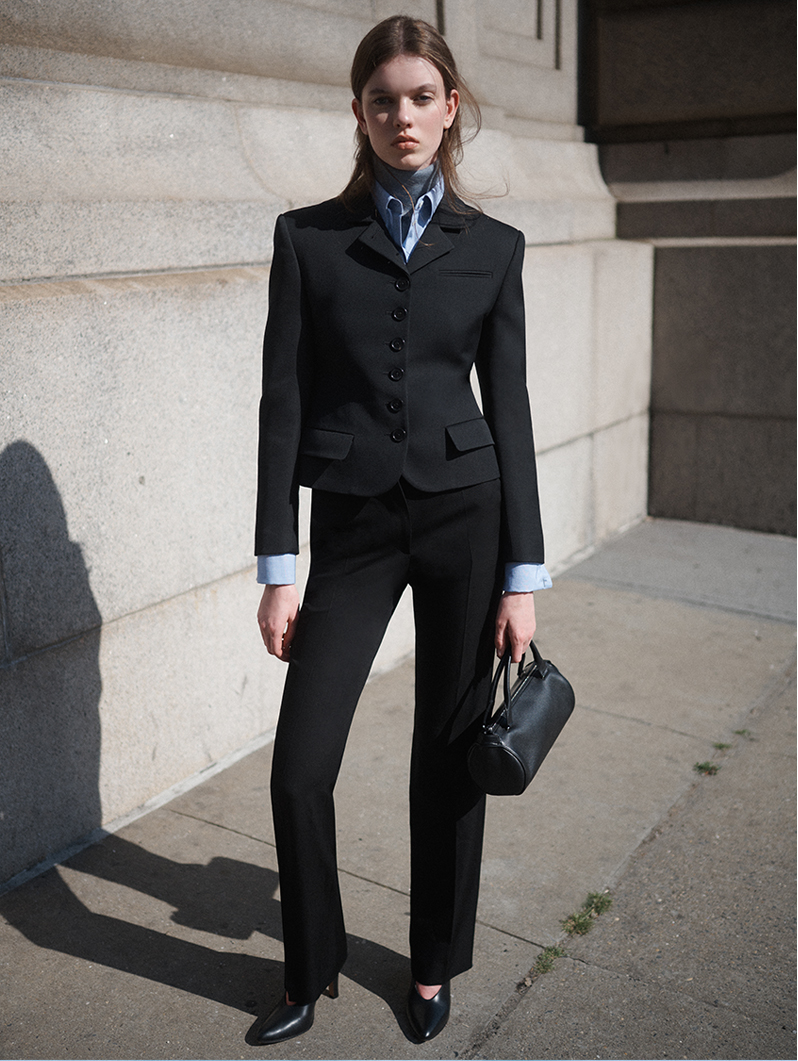 Model wears The Row - Fletcher Single-Breasted Wool Jacket and Jesse Pant in Wool