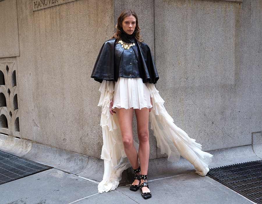 Model wearing Chloe Fall Collection; Soft Napa Leather Capelet Jacket and Draped Ruffle Sleeve Silk Mousseline Ruffle Mini Dress