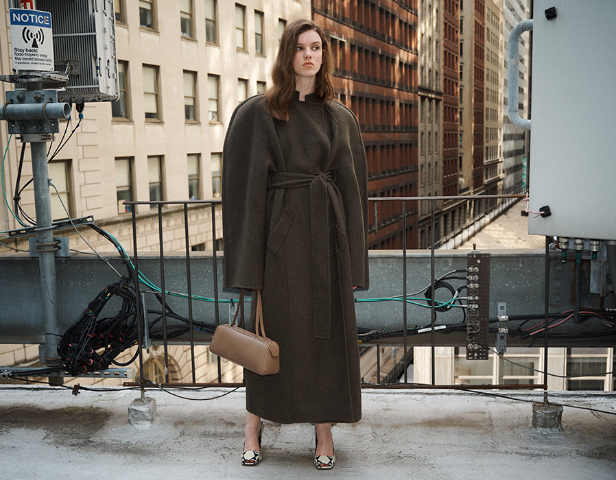 Model weearing Khaite Rothen Belted Double Face Wool Coat