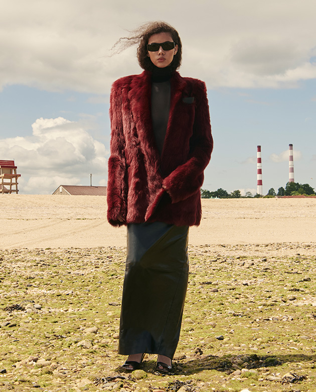 Model wears Khaite - Willow jacket in Oxblood shearling