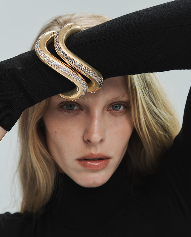 Model wears Pomellato bracelet