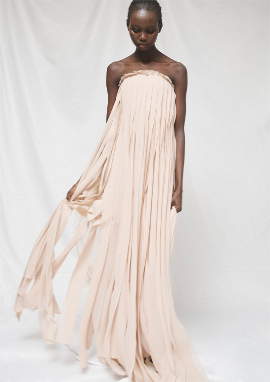 Model wears Akris - Strapless Silk Georgette Ribbon Gown