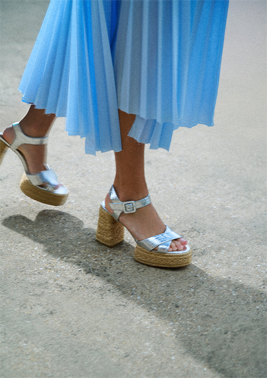 Model wears Christian Louboutin - Calakala Metallic Red Sole Espadrille Sandals