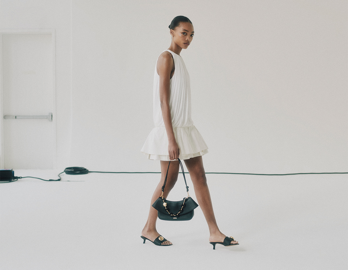 Model wears Loewe - Ola Medium Shoulder Bag in Calfskin Leather