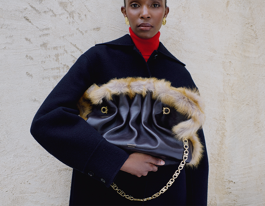 Model holds Ferragamo - Medium Gancio Piercing Shoulder Bag with Fur Trim