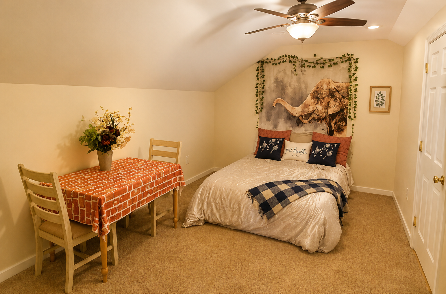 Upstairs guest bedroom with fresh flowers and a writing table at the retreat estate