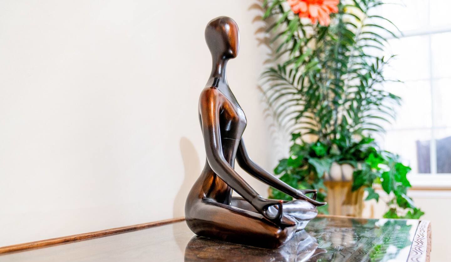 Meditation statue and greenery in a quiet corner of the retreat estate